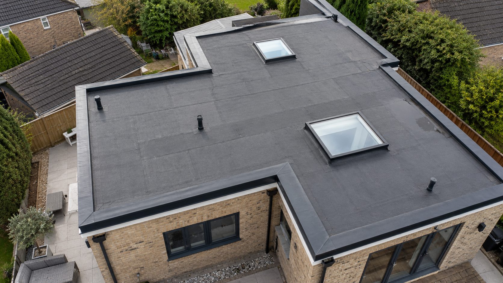 Flat roof with pipes and rooflights seen from above